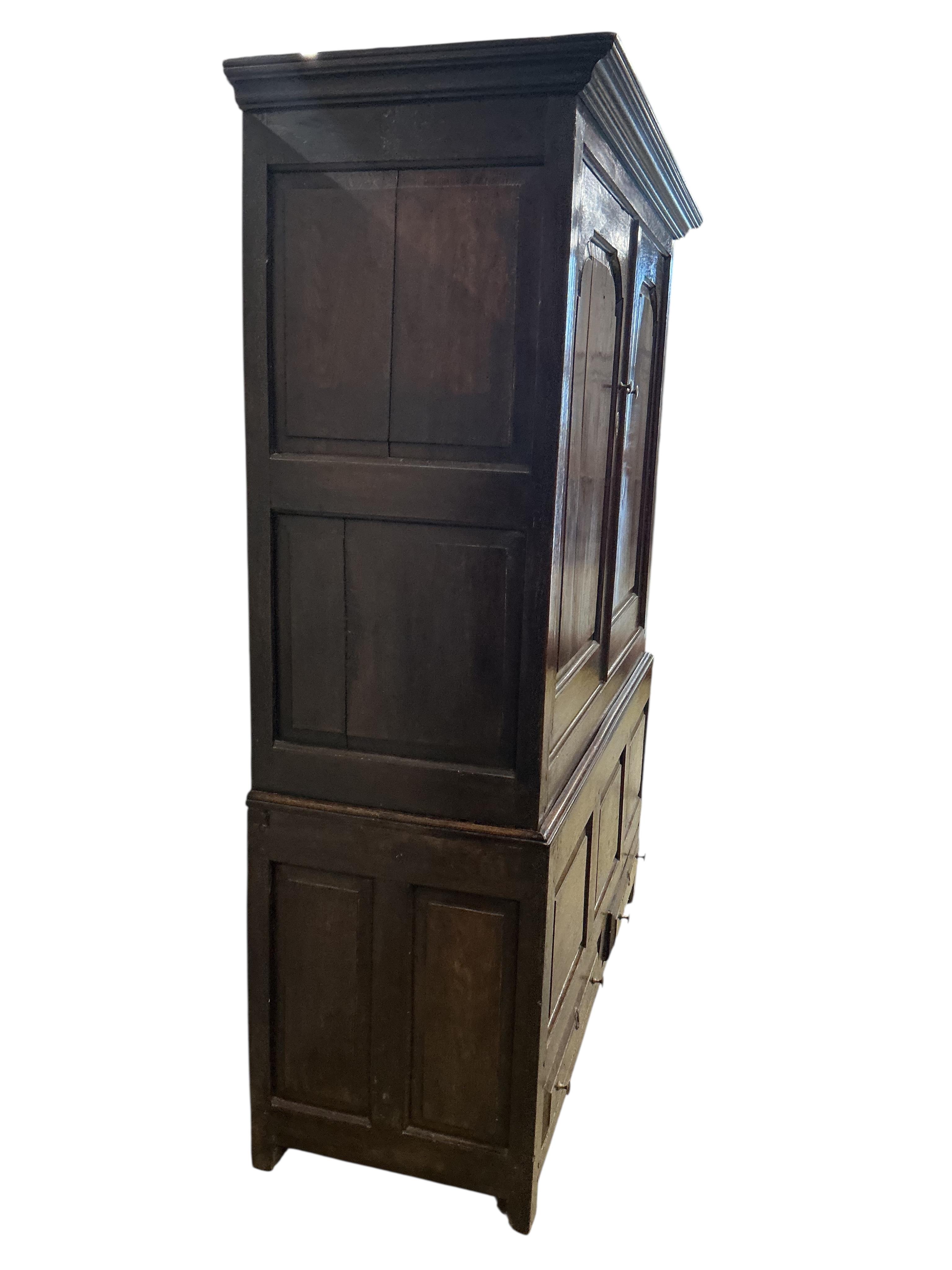 An 18th century oak two part hanging cupboard, width 139cm, depth 55cm, height 181cm
